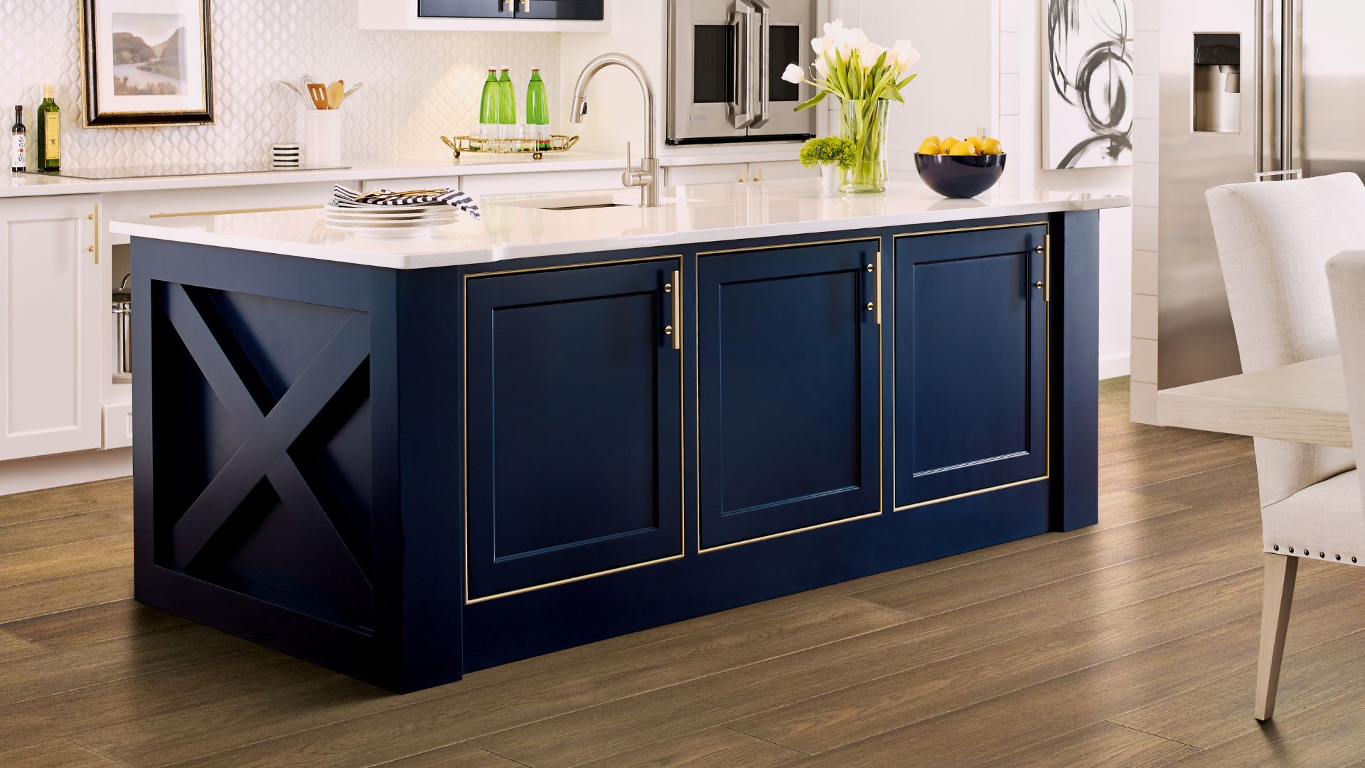 hardwood flooring in a bright kitchen with an island and white countertops